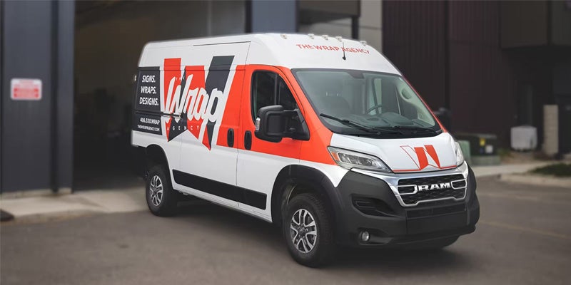 A photo of a 2024 RAM Promaster parked outside of a commercial building