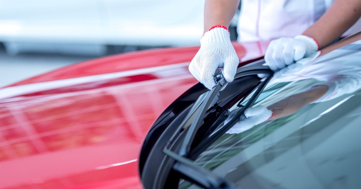 Jeep service tech inspecting wiper blades